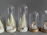 six glass cloches with snowmen and christmas trees in them
