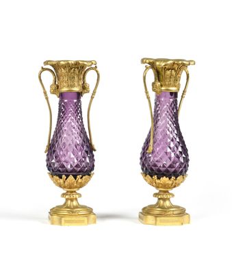 pair of purple glass vases with gold handles on a white background