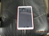 a cell phone sitting on top of a black leather chair