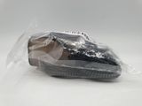 a close up of a shoe in a plastic bag on a white surface