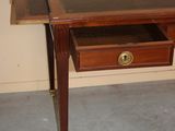 a small desk with a drawer on top of it