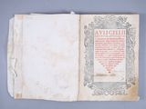 an old book with writing on it sitting on top of a table