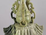 a statue of a woman with a hat on it ' s head