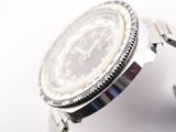 a close up of a watch on a white surface