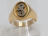 a close up of a gold and diamond signet ring