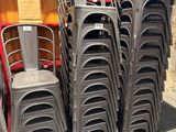 a lot of chairs that are stacked on top of each other