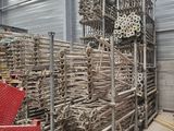 un gros tas de tuyaux métalliques dans un entrepôt