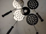 four different types of kitchen utensils sitting on a table