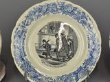 three blue and white plates with a picture of a man and a woman on them
