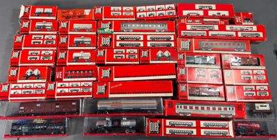 a lot of red and white train cars on a table