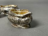pair of antique silverplated sugar and creamers on a table
