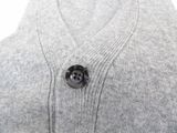 a close up of a sweater with a button on it