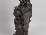 statue of a man holding a stack of books on a white background
