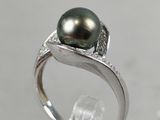 an image of a ring with a black pearl and diamonds