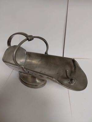 a metal object that is on a white surface