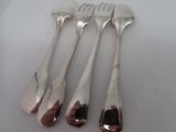 four forks and two spoons on a white table