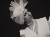 black and white photograph of a woman in a white dress and a veil