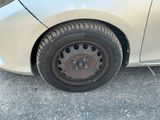 a white car with a flat tire on the street