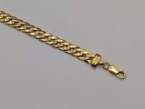 a gold chain bracelet with a clasp on a white background