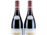 two bottles of wine sitting next to each other on a white surface