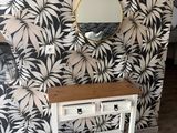 a small table with a mirror on it in a room