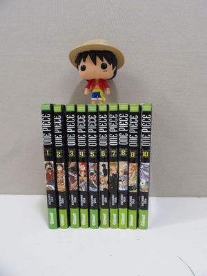 a small figurine of a man on top of a stack of dvds