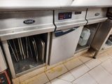 stainless steel counter top in a commercial kitchen with a bunch of utensils in it