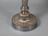 a silver candle that is sitting on a table