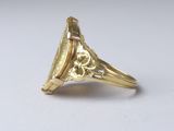an image of a gold ring with an oval stone in the center