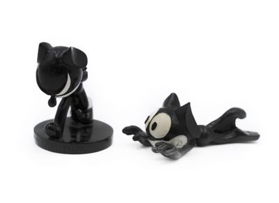 two figurines of a cat and a dog on a white surface