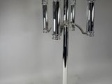 a tall silver candelier with four candles on it