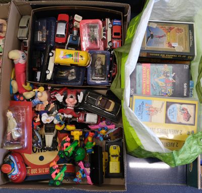 a box full of toys and other items on the floor