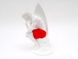 a figurine of a man sitting on top of a toilet