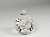 a clear glass jar with a lid on a white surface