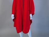 a mannequin wearing a red coat and black pants