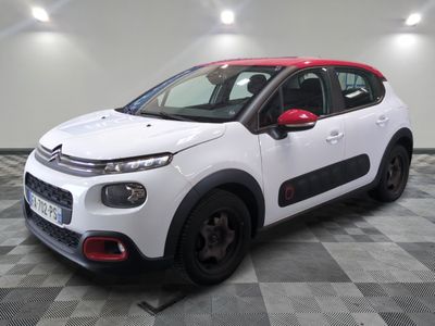 a white citrole car parked on a checkered floor in a garage