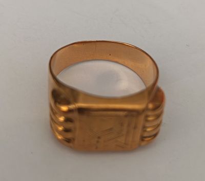 a close up of a gold ring on a white surface