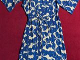 blue and white floral dress on a red surface