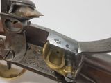 a close up of a gun on a white surface