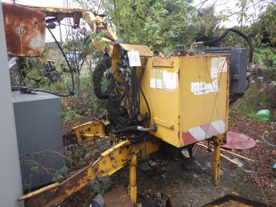 une machine jaune qui est garée dans la poussière