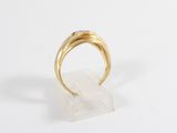 a close up of a gold ring on a white surface
