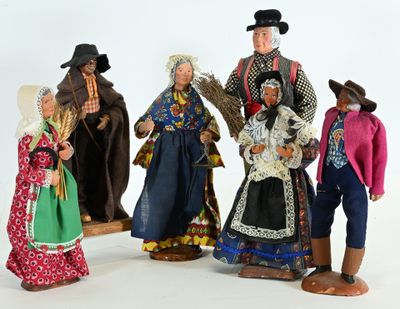 five figurines of people dressed in traditional clothing