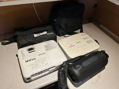 a laptop and other electronics sitting on a counter