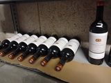 several bottles of wine are lined up on a shelf in a wine cellar