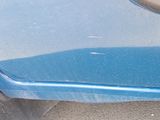 a close up of a blue car door handle