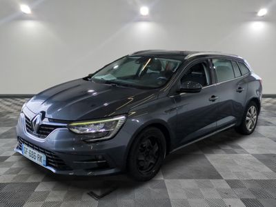 a grey car parked in a room with a checkered floor