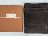 a wallet and a notepad sitting next to each other on a table