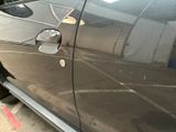 a close up of a car door handle with a sticker on it