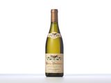 the bottle of white wine is sitting on the table