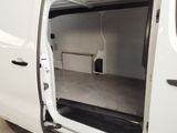 a white van with the door open in a garage